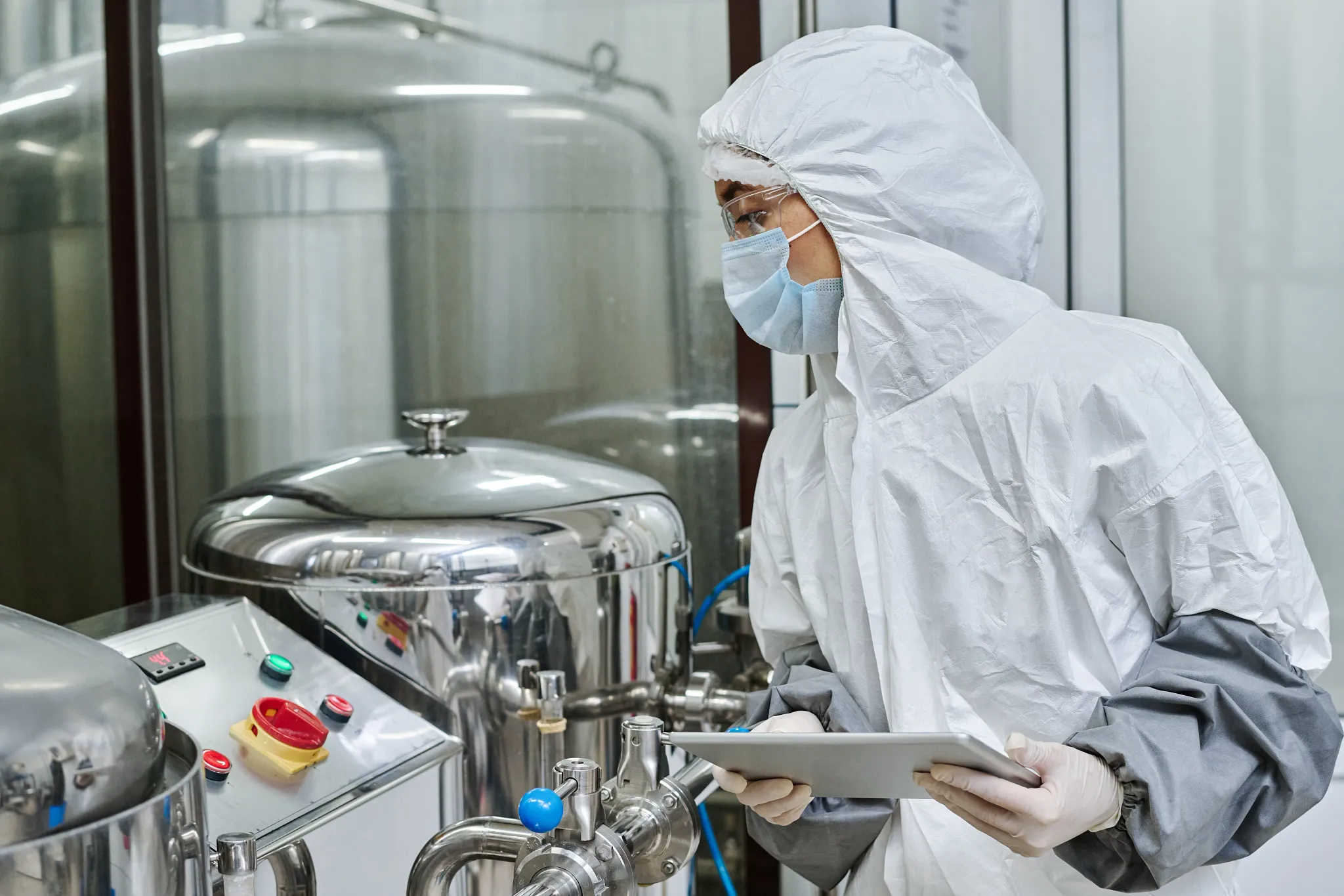 Stock-Photo-Pharma-Woman-Looking-at-Equipment.webp